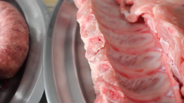 Selection of Raw Pork and Beef Meat Variety on Stainless Steel Platters Prepared for Grilling