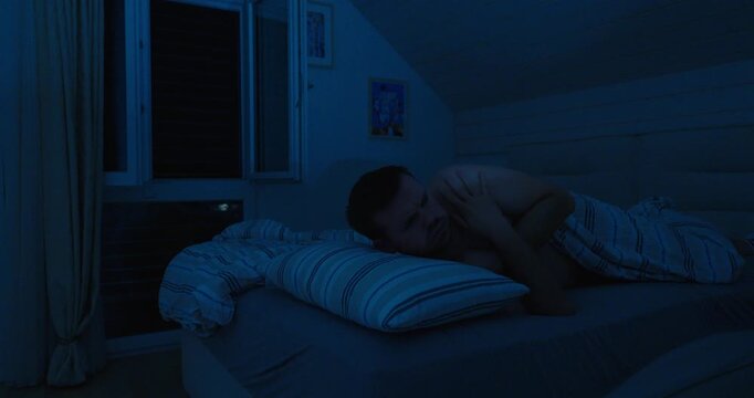 Man Feeling Cold at Night and Closing Window in Bedroom