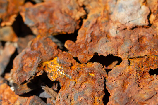 Rust corrosion metal texture iron oxide peeling surface closeup of weathered steel with flaky red patina and rough cracked detail, gritty industrial background for decay concept