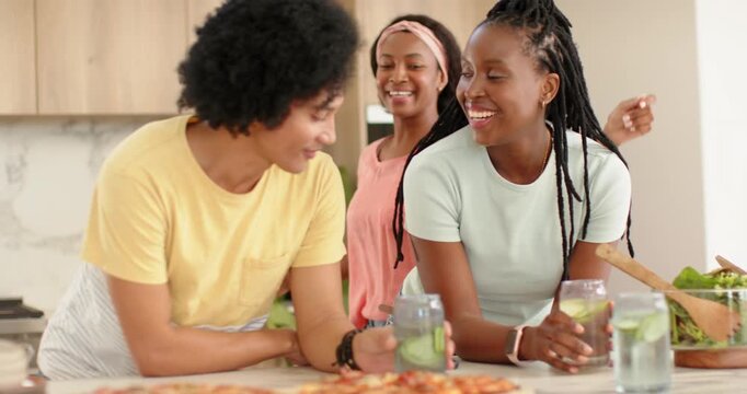 African American friends embracing at counter while woman coming with salad bowl and phone toasting
