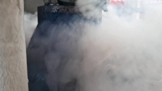 Dangerous high pressure steam leak from a rusty industrial pipe valve