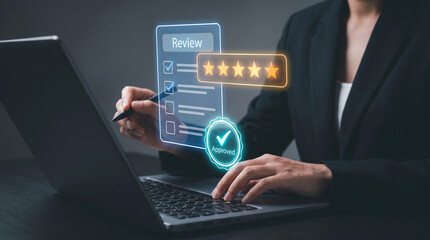 Fototapeta premium Businesswoman reviewing five-star rating and approved checklist on virtual interface by laptop