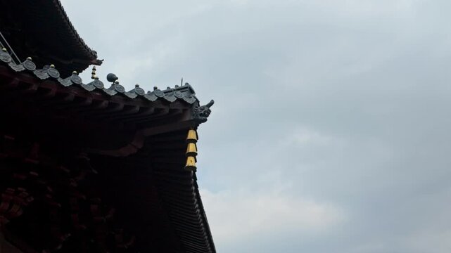 Close-up of wind chimes on the roof of Leifeng Pagoda