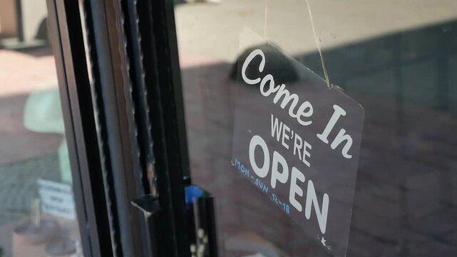Open sign hanging at a cafe in the afternoon light