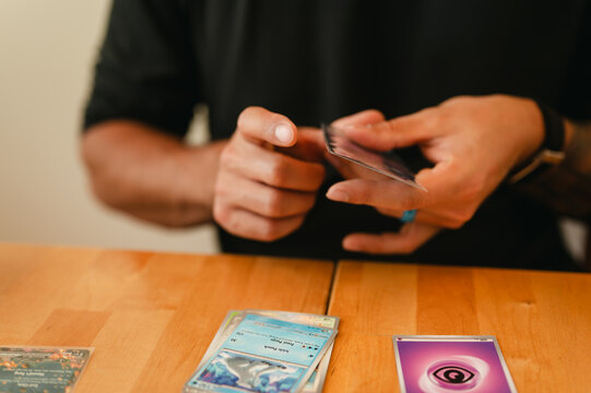 pokemon card in hand TCG: 3 Booster Packs & 1 Random Foil A person holding a card