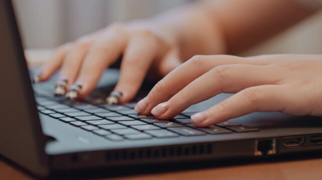 Keyboard fingertips editing. Stylish hands on laptop screen. Beauty blogger working with manicured nails. Closeup of nails and fingers as blogger edits and schedules social media content