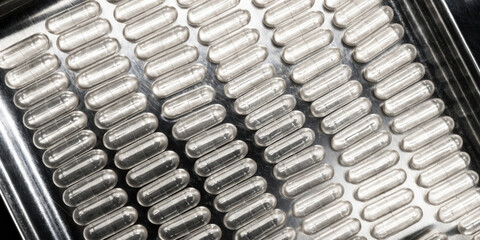 Fototapeta premium Medical technology clear capsule blister pack with reflective foil and repetitive pattern conveying clinical precision and care