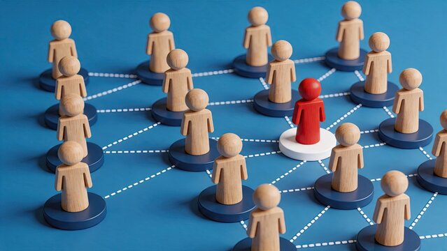 Wooden figures connected by dotted lines forming network with red leader figure standing out, representing team leadership and organizational structure concept on blue background