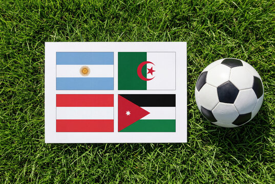 Flags of countries in a soccer tournament on grass with ball