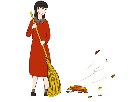 落ち葉掃除をする女性
