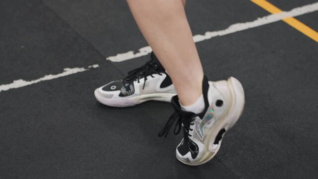Badminton footwork drill scene. Closeup shot of controlled badminton footwork and sharp movements. Detailed image capturing accuracy and timing of volleyball court foot positioning exercises