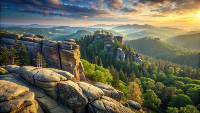 A rocky outcrop overlooks a dense forested valley with rolling hills