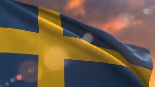 Swedish flag waving in sunset sky.