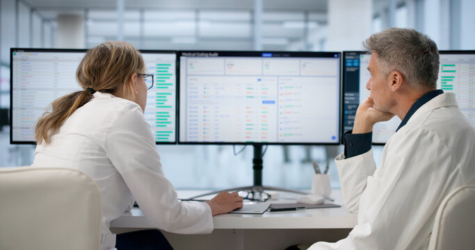 Administrator Frowns While Reviewing Stressful Medical Billing Spreadsheets.