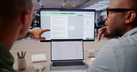 Contract Manager Reviews Digital Agreements Using Software