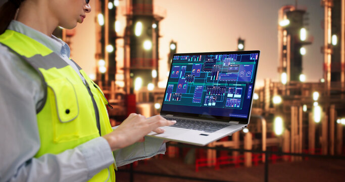 Young Female Engineer Uses Laptop To Monitor Energy Pipelines