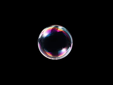Vibrant iridescent soap bubble isolated on a stark black background
