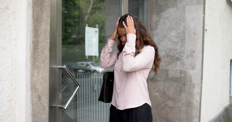 Fototapeta premium Sad Woman Stands Outside Her Door