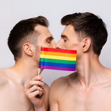 Two Men Embracing with Rainbow Flag Celebrating Pride Together