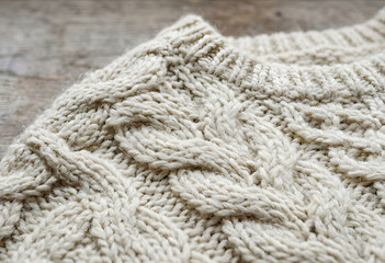 Fototapeta premium Close-up of cozy cream cable knit wool sweater