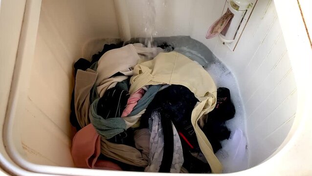 Pile of Clothes Ready for Washing in a Laundry Basket.