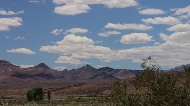 Beautiful sky and clouds over the lake, trees, and distant mountains at Pahranagat National Wildlife Refuge in Nevada