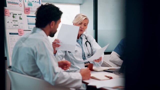Doctor, team and talk in hospital with documents, medical staff turnover and stats for mortality rate. Healthcare, people and meeting in clinic with paperwork, data and graphs for employee retention.