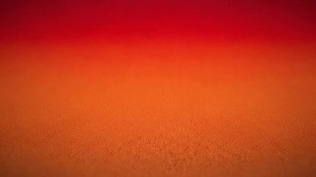 A vibrant abstract background featuring a smooth gradient of red and orange tones