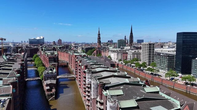 Hamburg, Germany - 28 May 2026: Aerial view of the historic Speicherstadt warehouse district with its red brick buildings, canals, and the Elbphilharmonie in the distance.