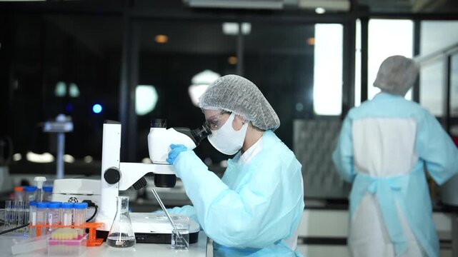 Lab work, scientists holds a test tube takes the test from a test tube in analysis for vaccine development.