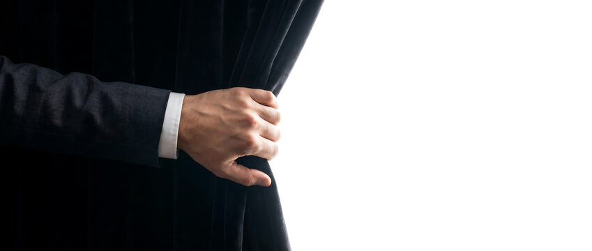 Man in Suit Pulling Open a Black Curtain Revealing a Bright White Space