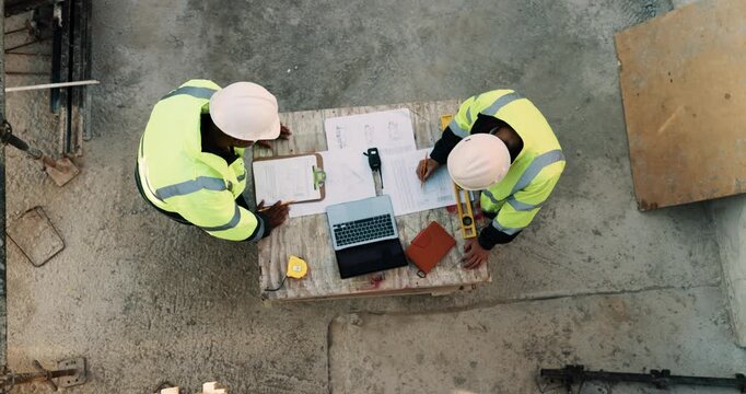 Construction, blueprint and above of people for planning, building project and inspection outdoor. Civil engineer, meeting and men with paperwork and tech for floorplan, design or infrastructure team