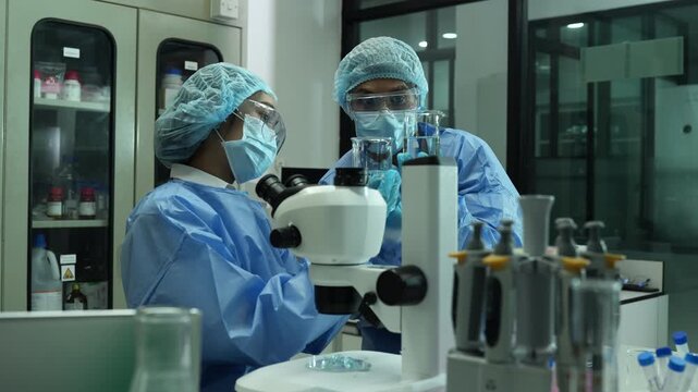 Environmental scientist testing water quality sample for microplastics and chemical contaminants in laboratory.