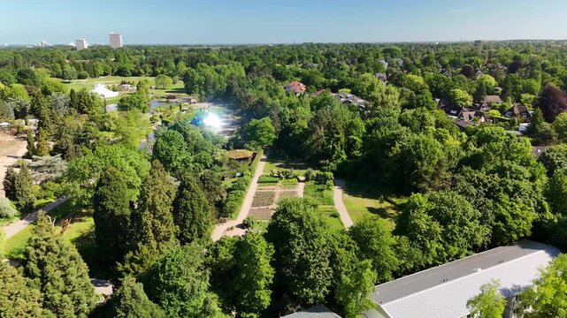 Hamburg, Germany - 27 May 2026: Aerial view of Loki Schmidt Garden with lush green trees and botanical plant beds under a clear blue sky.