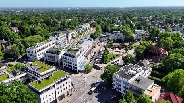 Hamburg, Germany - 27 May 2026: Aerial view of Blankenese district featuring modern architecture with green rooftops surrounded by lush green trees under a clear sky.