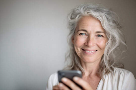 Tech-savvy senior confidently managing finances via mobile banking, representing digital inclusion and financial independence. Eldelry senior woman using cellphone, smartphone, modern technology.