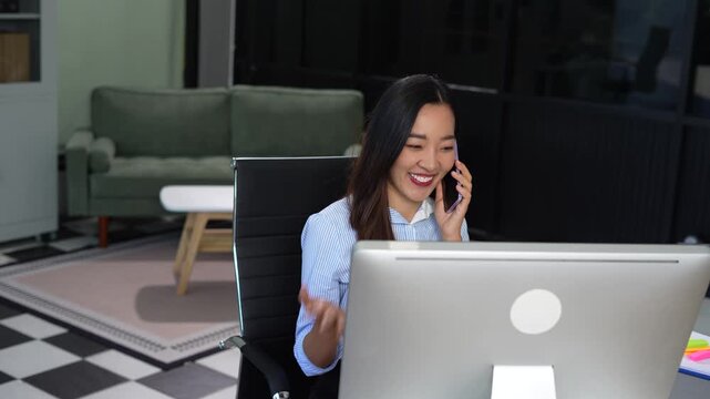Asian businesswoman involved in cellphone call conversation giving professional consultation to client or negotiating project.