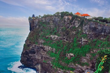      Bali, Indonesia - June 7, 2022: The Uluwatu Temple on a Cliff. Perched dramatically on a steep cliff, Uluwatu Temple stands at an elevation of 97 meters above sea level, offering breathtaking oce © Scotts Travel Photos