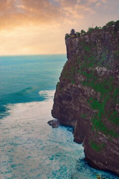 




Bali, Indonesia - June 7, 2022: The Uluwatu Temple on a Cliff. Perched dramatically on a steep cliff, Uluwatu Temple stands at an elevation of 97 meters above sea level, offering breathtaking oce