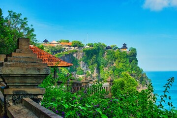      Bali, Indonesia - June 7, 2022: The Uluwatu Temple on a Cliff. Perched dramatically on a steep cliff, Uluwatu Temple stands at an elevation of 97 meters above sea level, offering breathtaking oce © Scotts Travel Photos