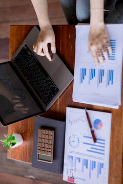 Business Financial Analysis on Laptop with Reports and Calculator