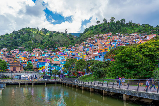 Colombia, Medellin, Comuna 3, Manrique, water reservoir and colourful painted houses built on a slope.