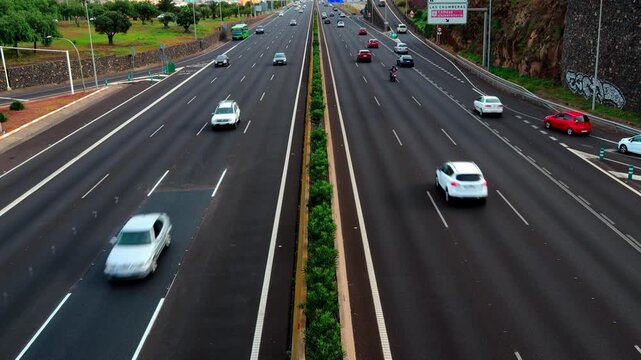 Busy highway traffic with cars driving on multi-lane asphalt road, aerial view of urban expressway transportation, morning commute on city motorway