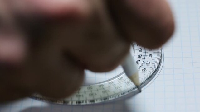 Drawing with a pencil under an oval ruler on a white sheet, drawing under a ruler
