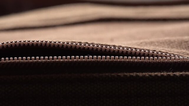 Zip fastener on a brown bag, macro of zip fasteners