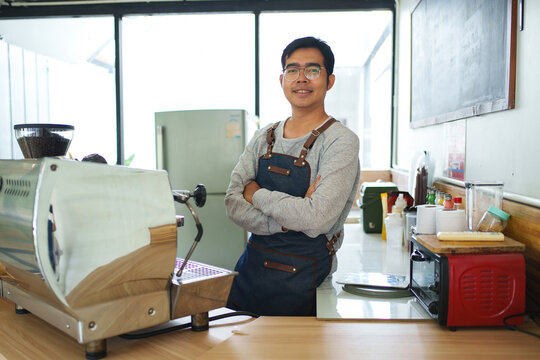 Smiling Barista Standing in a Coffee Roasting Workshop