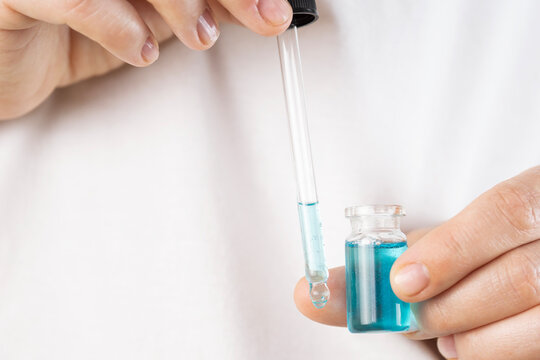 ghk cu peptide liquid pipette vial hands alternative mots c injection cosmetology close up view looking away concept of biochemistry, healthcare, pharmacology