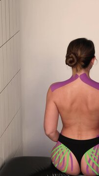 Kinesiology tape on the model's shoulders provides posture correction.