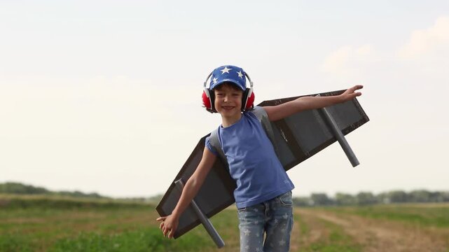 A happy child runs around the field with a toy jetpack