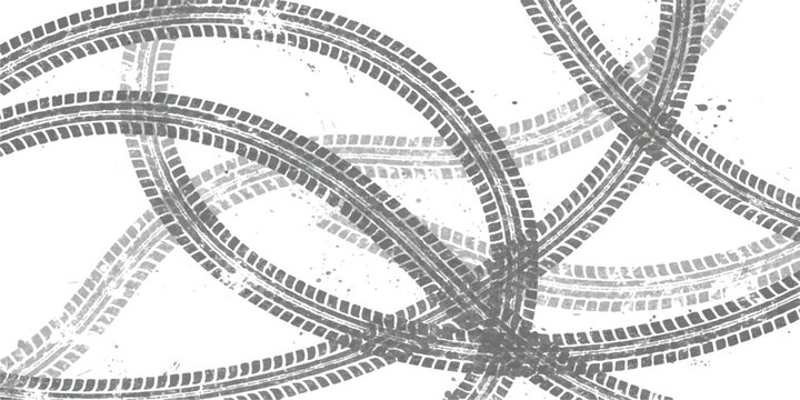 Black tire tracks forming circular patterns and intersecting lines